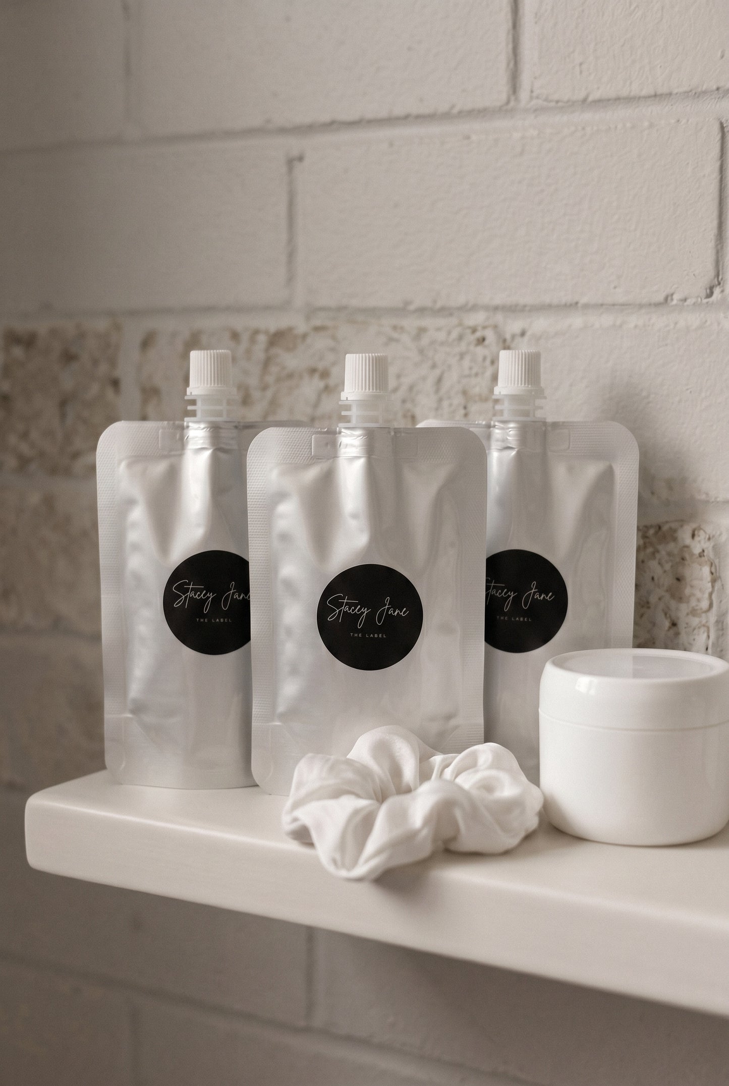 Stacey Jane business fragrances and custom scents display bottles with elegant packaging on a white background.