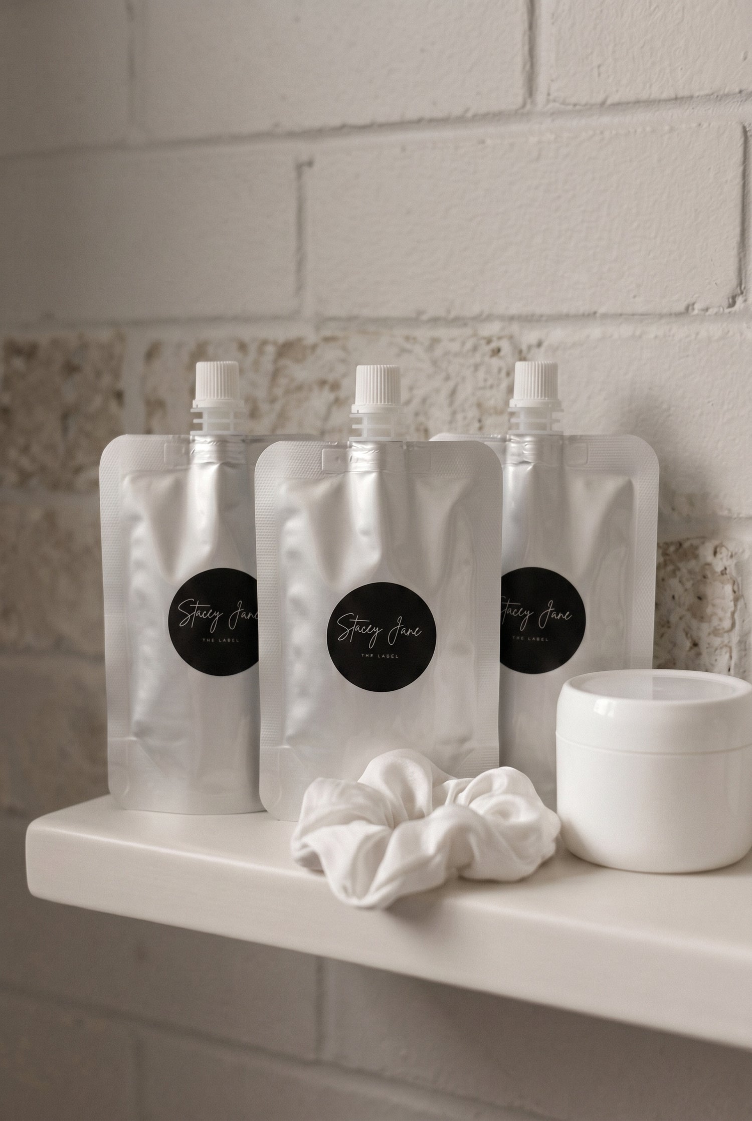 Stacey Jane business fragrances and custom scents display bottles with elegant packaging on a white background.