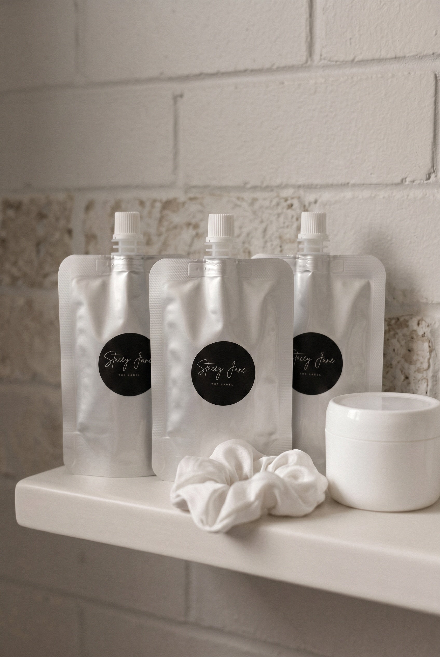 Stacey Jane business fragrances and custom scents display bottles with elegant packaging on a white background.